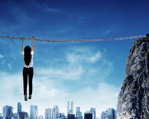Asian business person hanging on chain