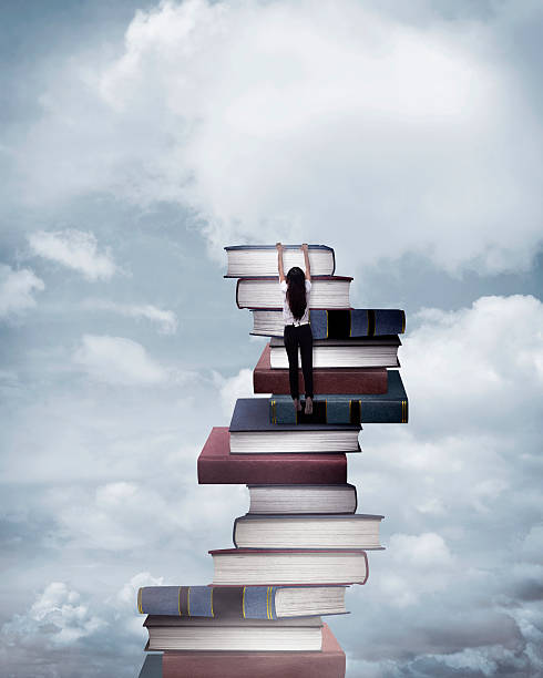 istock Asian business woman climbing book 520796922