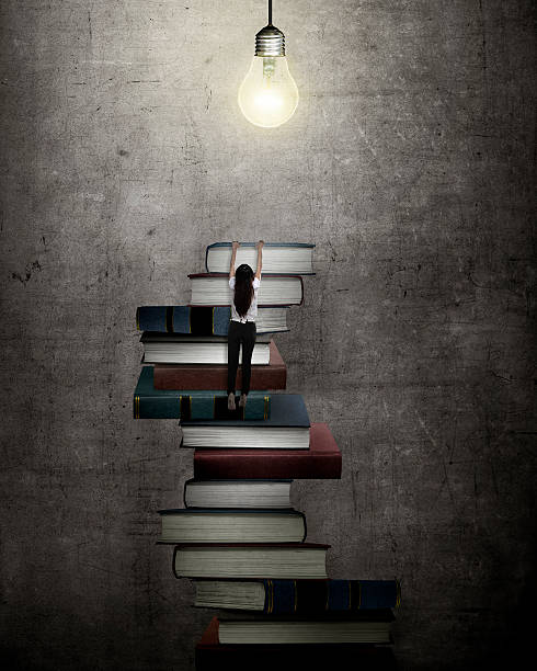 istock Asian business woman climbing book 520796954