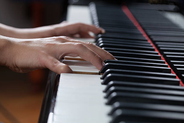 istock Woman playing piano 520797026