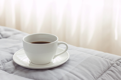 coffee cup in the morning on the bed background