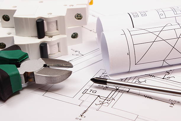 istock Work tools, electric fuse and rolls of diagrams on drawing 520801056