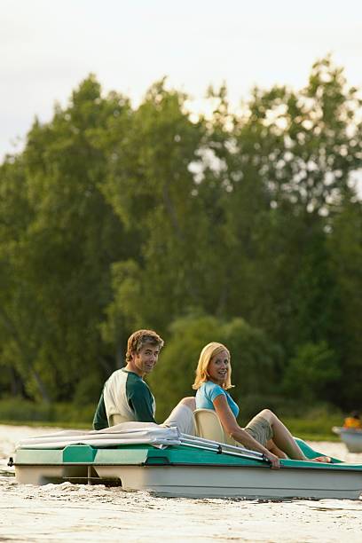 Couple on a lake Couple on a lake couple punting stock pictures, royalty-free photos & images
