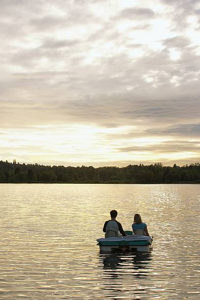 Couple on a lake Couple on a lake couple punting stock pictures, royalty-free photos & images