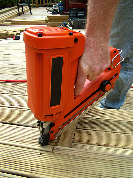 istock Hand holding nail gun, framing gun 520803249