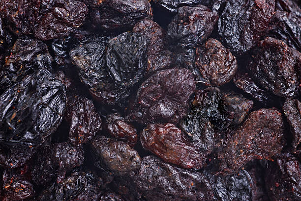 istock dark dried raisins close- up food background 520803689