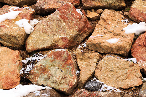 istock Fragment of wall from a chipped stone in Alps mountains 520805518