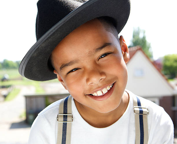 Cute little boy smiling with hat outdoors