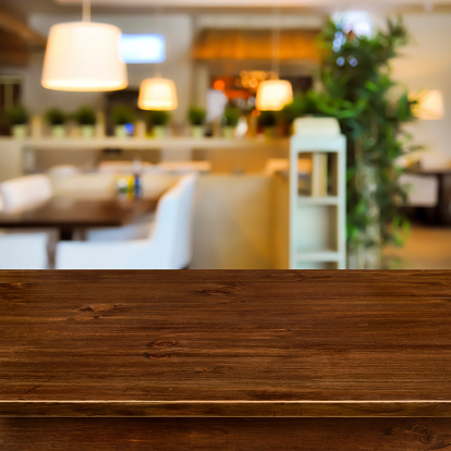 Wooden table on blurred room interior background