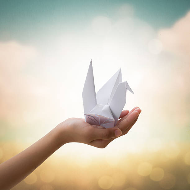 istock Origami bird on children's hand 520806204