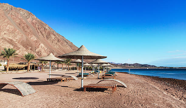 sunshades on taba beach sunshades on taba beach egypt taba stock pictures, royalty-free photos & images