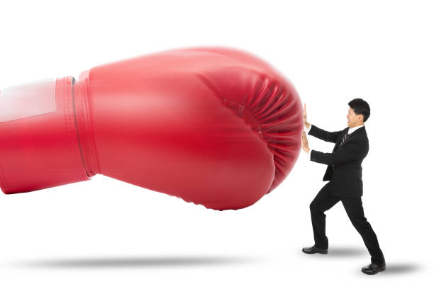 istock Businessman protect himself by push red glove punch him 520807221
