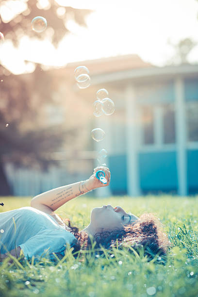 istock young beautiful moroccan curly woman blowing bubbles 520810501