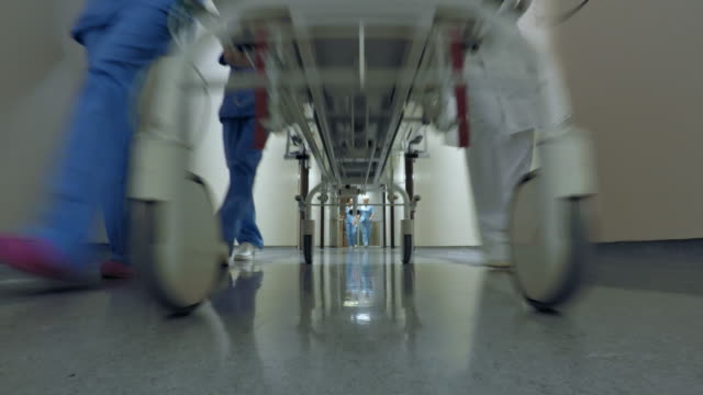 POV Medical team pushing a stretcher down the hospital hallway
