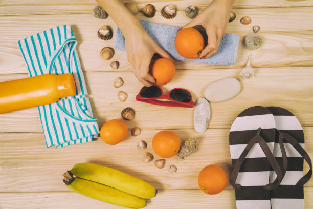 istock Beach accessories with fruits on wooden board. 520831274