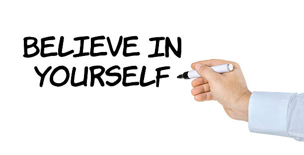 istock Hand with pen writing Believe in yourself 520831826