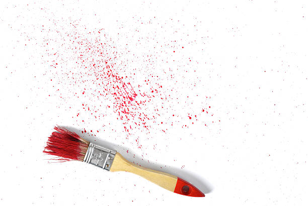 istock Paint brush with red gouache sprays near on white canvas 520832702