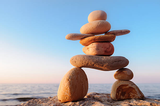 Symbolic figurine of stones Symbolic figurine of inukshuk of the pebbles cairns photos stock pictures, royalty-free photos & images