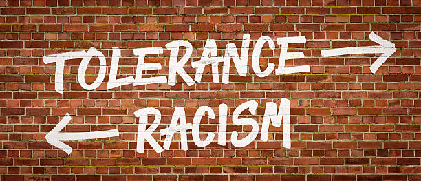 istock Tolerance or Racism written on a brick wall 520832858