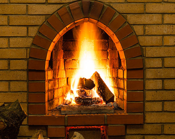 istock spurts of fire in brick fireplace 520834710