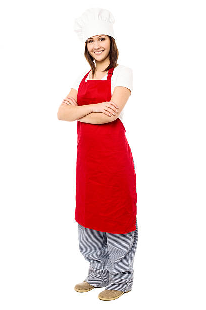 istock Lady chef wearing apron, full length shot. 520835000
