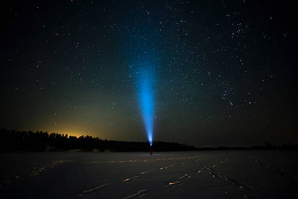 istock blue ray of flashlight in the starry sky 520835570