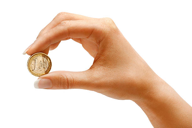 istock Womens hand holding a coin one euro 520836766