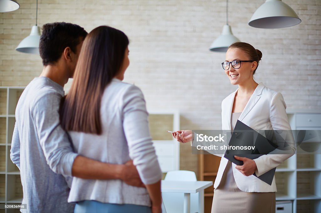 Your personal Real Estate Agent Woman Real Estate Agent talking to a young family Real Estate Agent Stock Photo