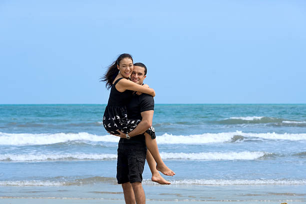 istock Happy interracial  couple enjoying on beach 520837260