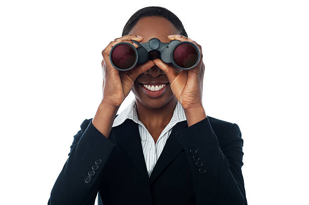 Business woman watching through binocular stock photo