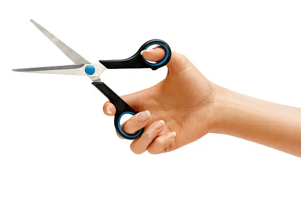 Photo of Scissors in female hand.