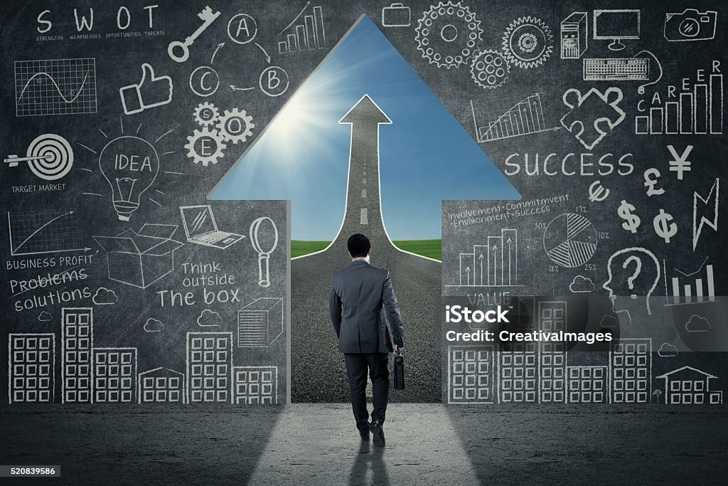 Worker entrance shaped upward arrow Male worker walking into the entrance shaped upward arrow with doodles on the wall Adult Stock Photo