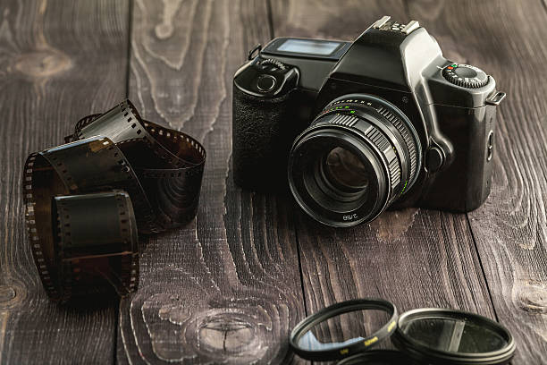 istock Photo camera on wooden rustic background 520839894