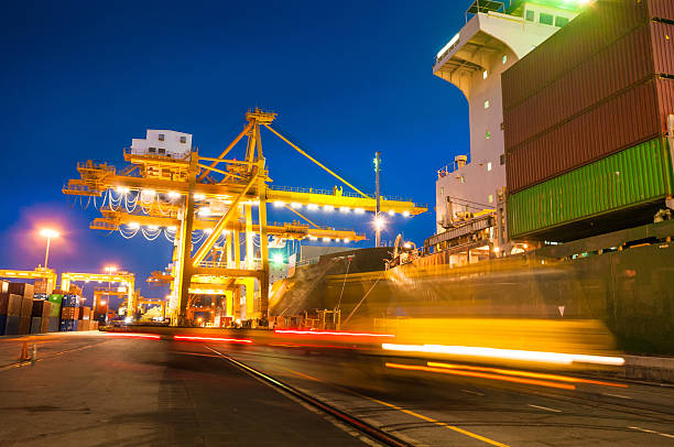 istock Cargo ship in the harbor at sunset . 520839923