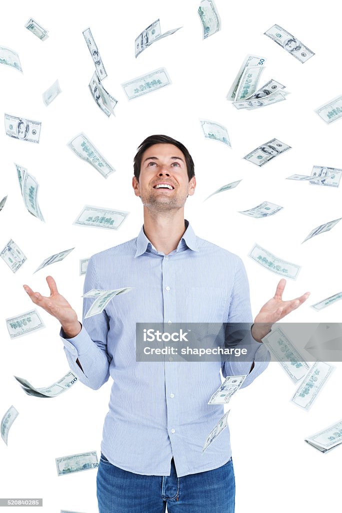 Someone just won the lottery Studio shot of a handsome young man surrounded by falling money Men Stock Photo