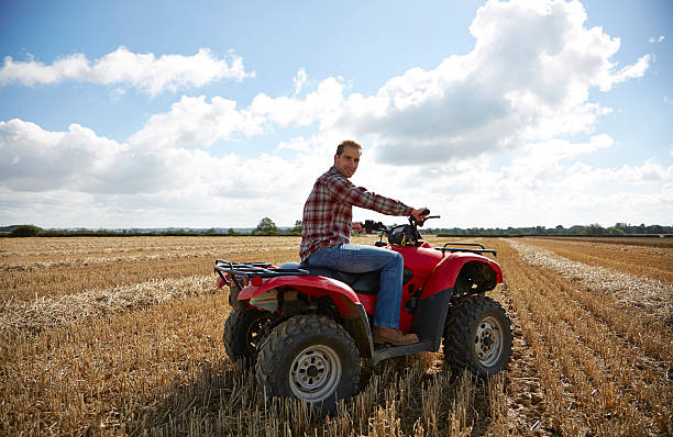 istock Farmer riding an ATV in a field 520840687
