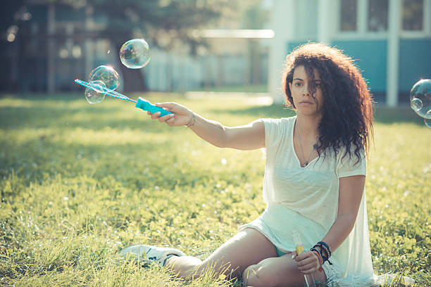 istock young beautiful moroccan curly woman blowing bubbles 520840873