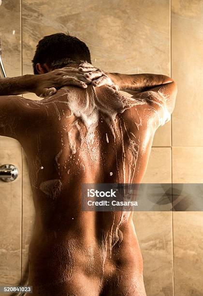 Young Man Showering Stock Photo - Download Image Now - Back, Men, Rear View