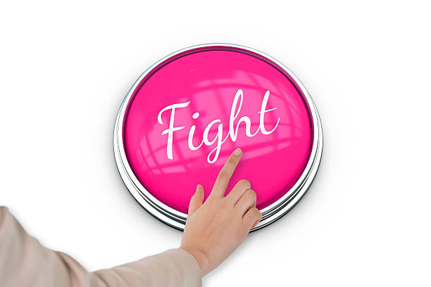 Hand pressing pink button for breast cancer awareness on white background