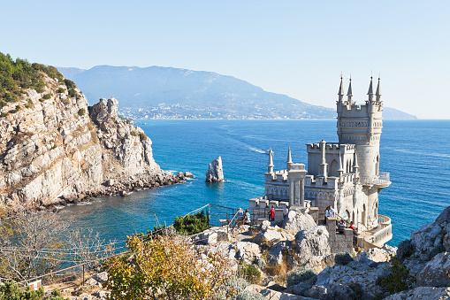Gaspra, Russia - September 29, 2014: Black Sea coastline with Swallow's Nest castle in Crimea. The castle was built in 1911-1912, on top of the 40-metre high Aurora Cliff