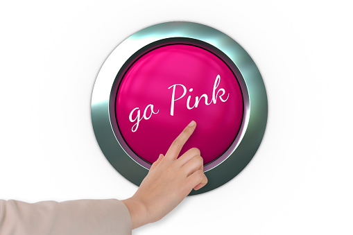 Hand pressing pink button for breast cancer awareness on white background