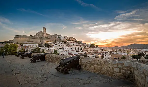 Ibiza fortress and cannon square at sunset. Eivissa island, Spain