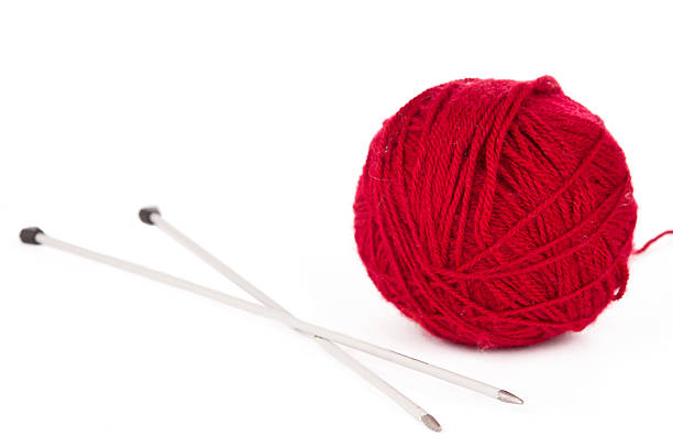 istock Knitting needles and red ball of yarn 520841908