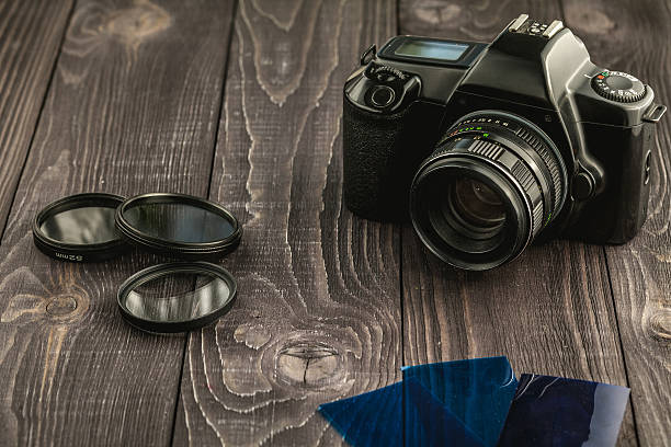 Photo camera on wooden rustic background