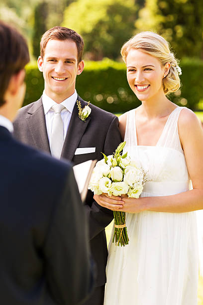 istock Groom And Bride Looking At Minister During Wedding 520842247