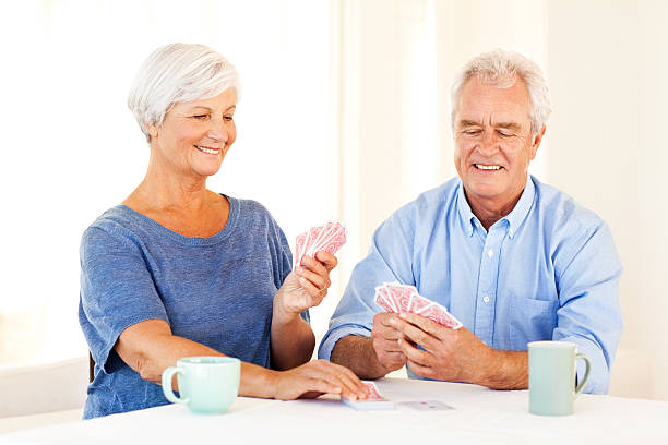 istock Senior Couple Playing Cards At Dining Table 520842779