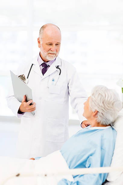istock Doctor Consoling Patient In Hospital Ward 520842827