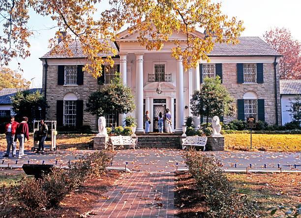 Graceland, Memphis. Memphis, United States - November 21, 1995: Front view of Graceland, the home of Elvis Presley with tourists enjoying the sights, during the Autumn, Memphis, Tennessee, United States of America. memphis tennessee stock pictures, royalty-free photos & images