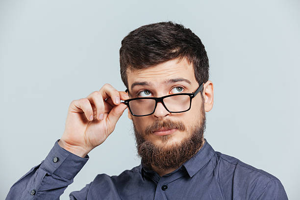istock Pensive man in glasses looking up 520844528