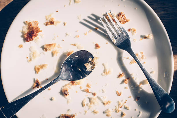 istock Dirty Dishes with Food Scraps on wood table 520844988
